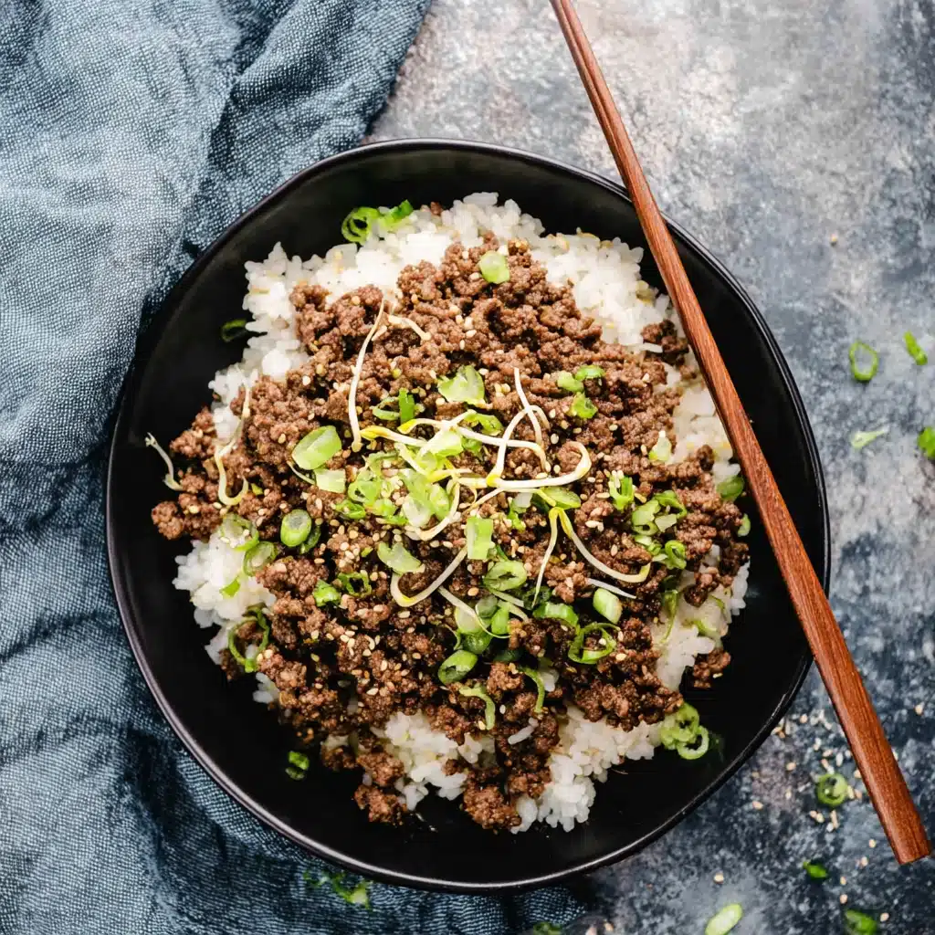 korean beef and rice bowl with green onions and sesame