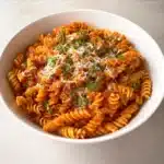 spicy tomato pasta in rustic bowl