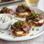 Steak crostini appetizer on baguette with horseradish cream